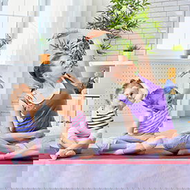 mom and 2 girls doing yoga to relax since we have the solution for head lice