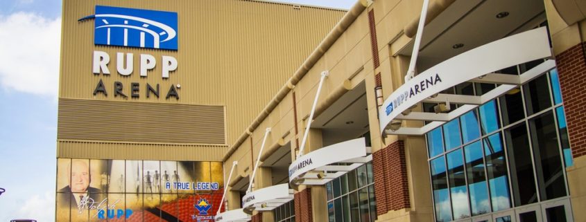Side view of the front entrance of Rupp Arena sunny sky with clouds in background