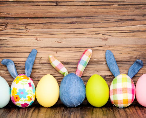 happy easter eggs on wooden table