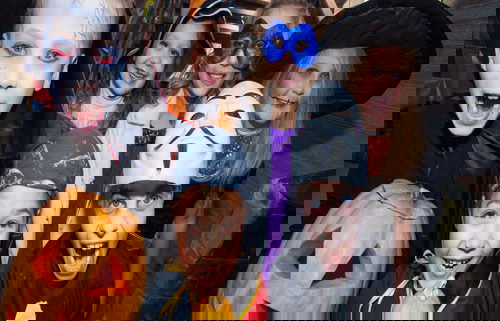 Children in halloween costumes show funny faces