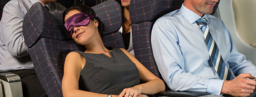 Business woman sleep during night flight airplane cabin passengers