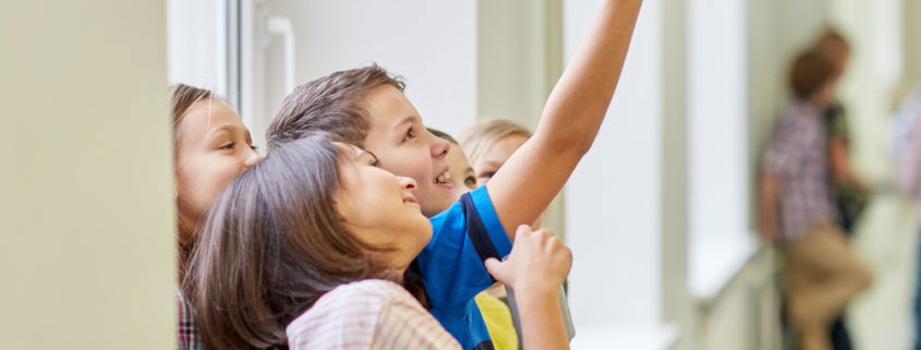 education, elementary school, drinks, children and people concept - group of school kids taking selfie with smartphone in corridor