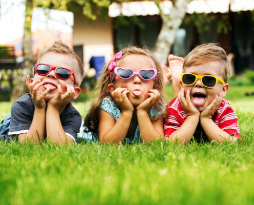 Trio children showing their tongues